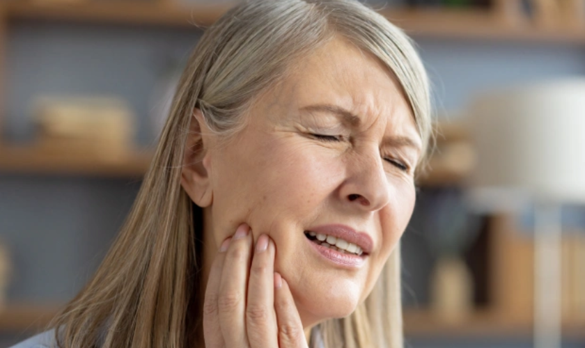 Patient holding jaw with tooth pain seeking emergency dental care in Riverview FL